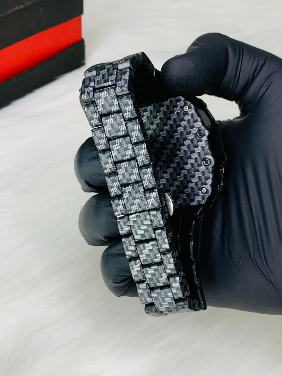 Carbon fiber watch held in hand